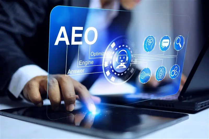 Business professional using a futuristic digital interface for AEO (Answer Engine Optimization) with icons representing AI, search, chatbot, analytics, and user interaction, symbolizing modern SEO and AI-powered search optimization.